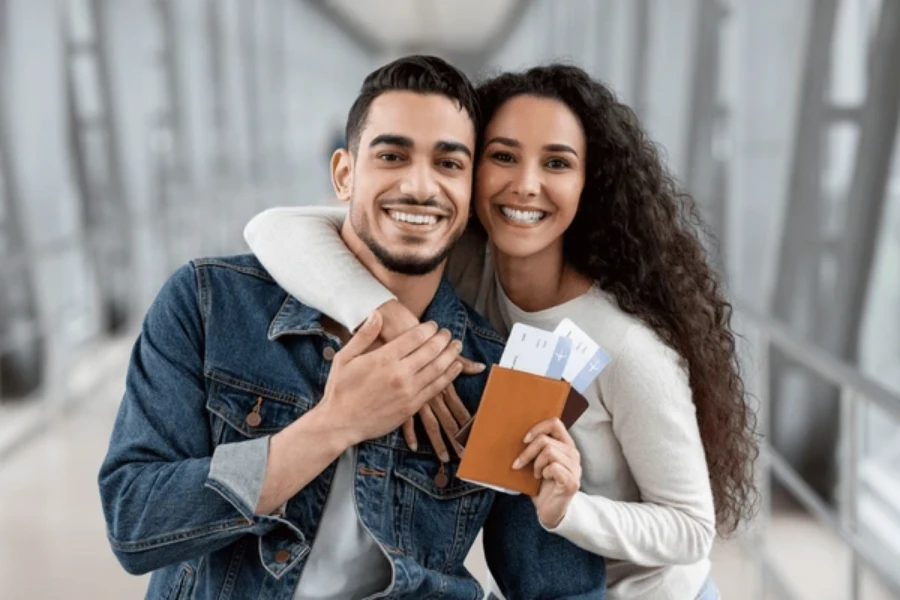 spouse visa approved for an indian couple smiling on the airport